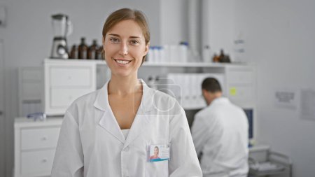 Photo for Two scientists, a woman and man, smiling together, working just like two mates in a lab, the heartwarming interior of a science-induced laugh-filled workplace - Royalty Free Image