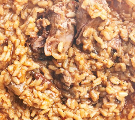 Photo for Close-up of traditional risotto with braised meat, cooked to a creamy texture in a bowl. - Royalty Free Image