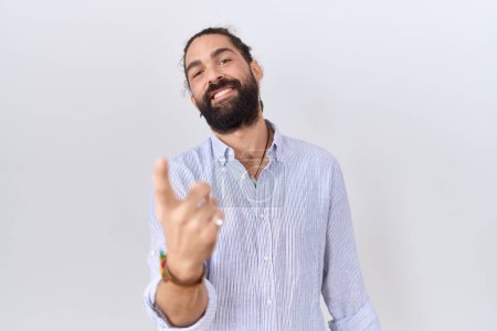 Photo for Hispanic man with beard wearing casual shirt beckoning come here gesture with hand inviting welcoming happy and smiling - Royalty Free Image