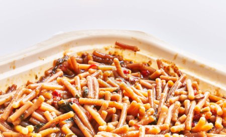 Photo for Close-up of traditional spanish fideua in a takeout container, suggesting a delicious seafood pasta meal for delivery or takeaway. - Royalty Free Image