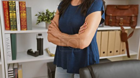 Photo for Confident woman standing in modern office setting, exuding professionalism and determination in business attire. - Royalty Free Image