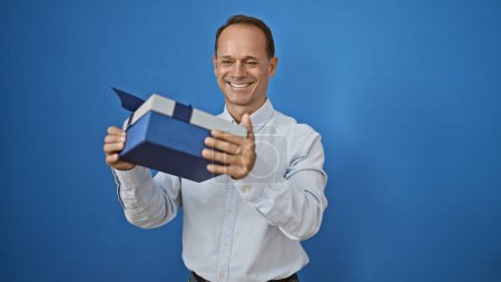 Photo for Middle age man smiling confident holding present over isolated white background - Royalty Free Image