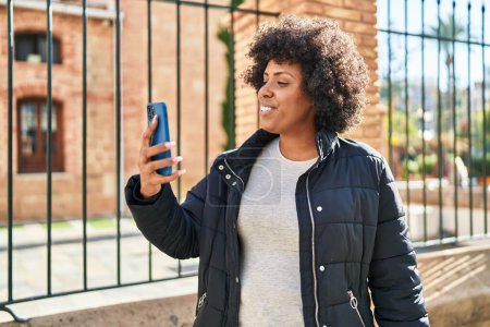 Photo for African american woman smiling confident having video call at street - Royalty Free Image