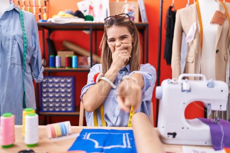 Photo for Hispanic young woman dressmaker designer at atelier room laughing at you, pointing finger to the camera with hand over mouth, shame expression - Royalty Free Image