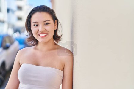 Photo for Young hispanic woman smiling confident looking to the side at street - Royalty Free Image