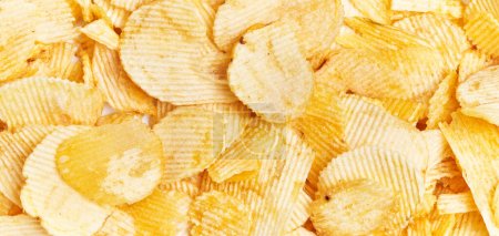 Photo for Close-up view of golden potato chips, showcasing a textured snack background with no people. - Royalty Free Image