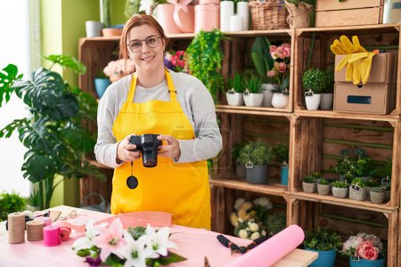 Photo for Young beautiful plus size woman florist make photo to bouquet of flowers gift at flower shop - Royalty Free Image