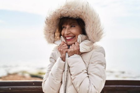 Photo for Middle age woman smiling confident freezing at seaside - Royalty Free Image