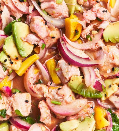 Photo for Close-up of a vibrant seafood ceviche with salmon, avocado, mango, onion, cilantro, and lime juice, reflecting fresh cuisine - Royalty Free Image