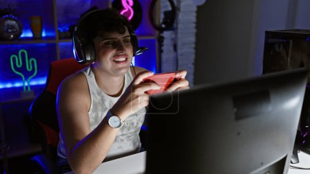 Photo for Young man gaming in dark home office with neon lights - Royalty Free Image