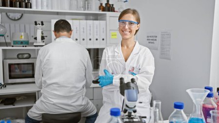Photo for Two amiable scientists, best mates, sitting with arms crossed, engrossed in serious lab work in a bustling medical research laboratory - Royalty Free Image