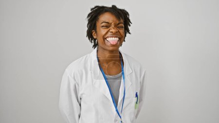 Photo for A cheerful young black woman with dreadlocks, wearing a lab coat, posing against a white background, exuding confidence and professionalism. - Royalty Free Image