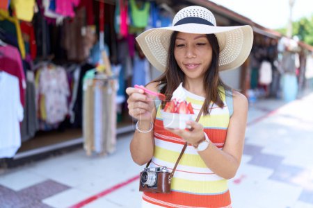 Photo for Young asian woman tourist eating ice cream standing at street market - Royalty Free Image