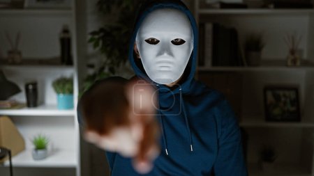An ominous man in a mask extends his hand in a blurred office setting, creating a mysterious and eerie atmosphere.