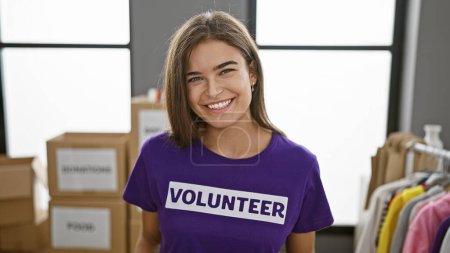 Photo for Confident beautiful hispanic young woman smiling as a volunteer at a charity center - Royalty Free Image