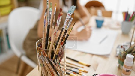 Photo for Passionate hispanic woman artist's hands drawing in art studio notebook amidst a creative rush - Royalty Free Image