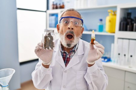 Shocked senior man stares in amazed fear at medicine cannabis in lab, his expressive face a mix of surprise and excited wonder