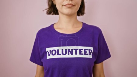 Photo for Stunning young hispanic woman, a volunteer working tirelessly on donations, exudes altruism and unity, standing concentrated over an isolated pink background portraying serious expression - Royalty Free Image