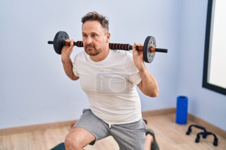 Photo for Young caucasian man training legs exercise at sport center - Royalty Free Image