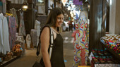 A smiling young adult woman explores the traditional souk in dubai, surrounded by arabian decor and textiles. Stickers #703165438