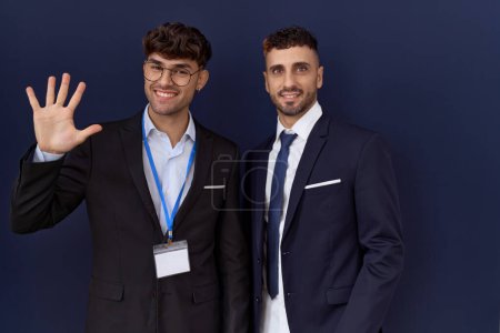 Photo for Two hispanic business men wearing business clothes showing and pointing up with fingers number five while smiling confident and happy. - Royalty Free Image