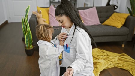 A girl mimicking a woman doctor using a stethoscope in a cozy living room radiating family and learning