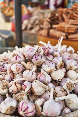 Photo for Delicious group of garlic on wicker bowl at street market - Royalty Free Image