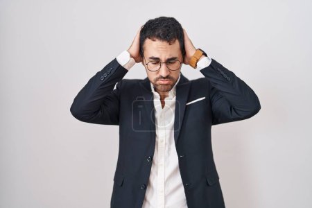 Photo for Handsome business hispanic man standing over white background suffering from headache desperate and stressed because pain and migraine. hands on head. - Royalty Free Image