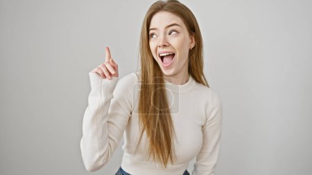 Photo for Happy young blonde woman in casual sweater gesturing an idea against a white isolated background - Royalty Free Image