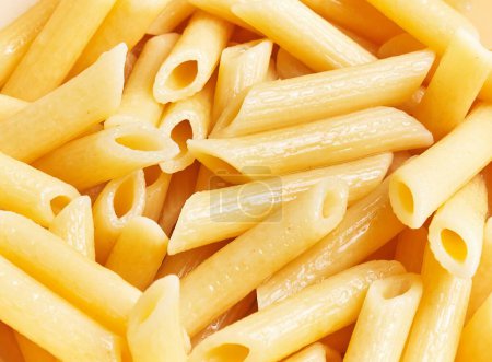 Close-up view of cooked pasta, showcasing the texture and simplicity of the italian cuisine staple.