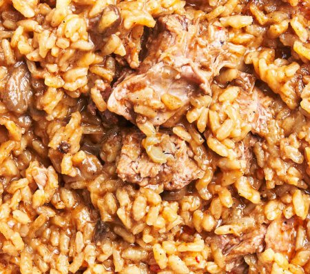 Photo for Close-up view of a traditional beef risotto dish, highlighting the rice texture and meat chunks - Royalty Free Image