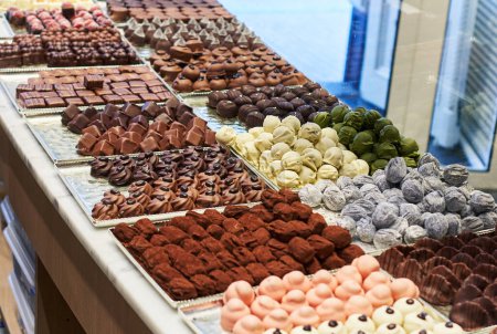 Assorted chocolates displayed in a confectionery store, tempting with variety and sweetness.