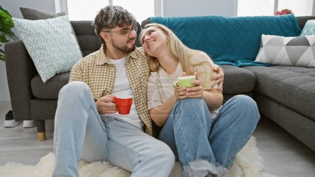 A loving couple relaxing together with coffee in a cozy living room setting, embodying a sense of home and comfort.