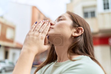 Photo for Young beautiful woman praying with closed eyes at street - Royalty Free Image