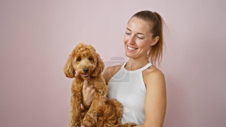 Photo for Young caucasian woman with dog smiling hugging over isolated pink background - Royalty Free Image
