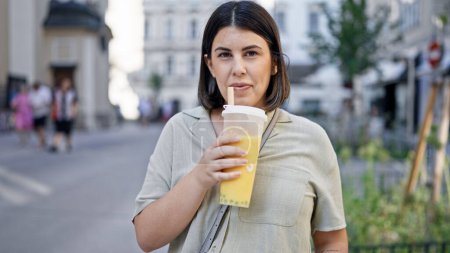 Photo for Young beautiful hispanic woman drinking bubble tea in the streets of Vienna - Royalty Free Image