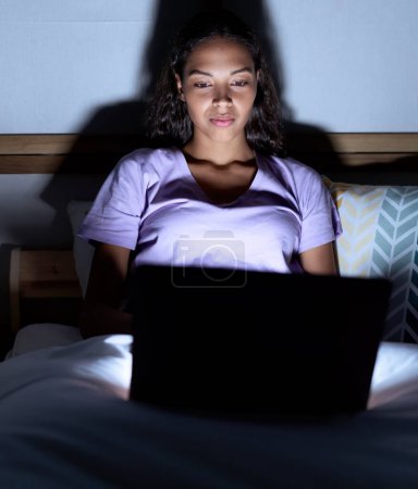 Téléchargez les photos : Young african american woman using laptop sitting on bed at bedroom - en image libre de droit