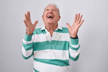 Photo for Senior man with grey hair standing over white background celebrating mad and crazy for success with arms raised and closed eyes screaming excited. winner concept - Royalty Free Image