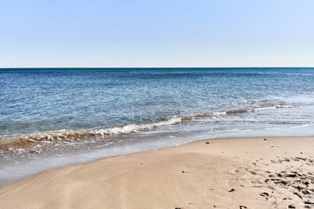 Photo for Tranquil beach scene with clear blue sky, golden sand, turquoise sea, and no people, depicting a serene holiday destination. - Royalty Free Image