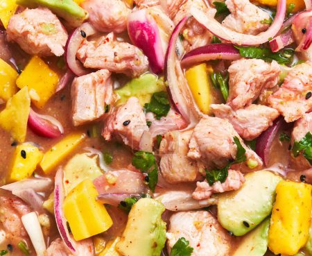Photo for Close-up of a vibrant peruvian ceviche dish with fresh seafood, avocado, red onions, and cilantro, perfect for culinary concepts. - Royalty Free Image