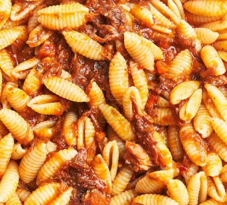 Close-up italian pasta with savory beef ragu, perfect for culinary and food-related content.