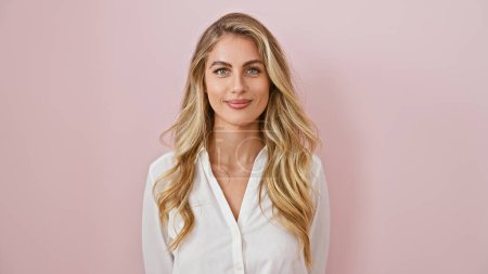 Photo for Bright and joyous, a confident, young blonde woman radiating positive energy, joyfully smiling and standing isolated over a vibrant pink background! - Royalty Free Image