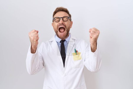 Photo for Middle age doctor man with beard wearing white coat excited for success with arms raised and eyes closed celebrating victory smiling. winner concept. - Royalty Free Image