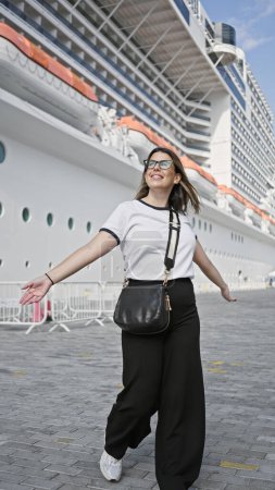 A joyful young woman embarks on a luxury cruise trip, evoking leisure and travel at sea.