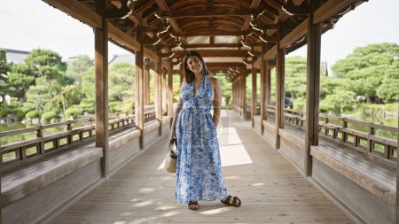 Photo for Beautiful hispanic woman, a radiant portrait of happiness and confidence, smiling and posing joyfully at traditional heian jingu in kyoto, japan, portraying carefree fun and success - Royalty Free Image
