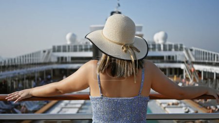 Photo for A young woman enjoys her vacation on the deck of a cruise ship, gazing at the sea under a clear sky. - Royalty Free Image