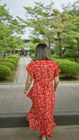 Beautiful hispanic woman donning glasses walking in awe, embracing the old world charm at gotokuji temple - a must-see tokyo destination