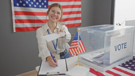 Smiling young woman casting ballot at a u.s. election with american flag in the background