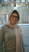Smiling young woman wearing glasses and hijab inside a historical mosque in istanbul Poster #710172258