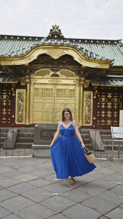 Lächelnde schöne hispanische Frau mit Brille posiert selbstbewusst am Ueno Park Tempel und strahlt Freude und Erfolg aus